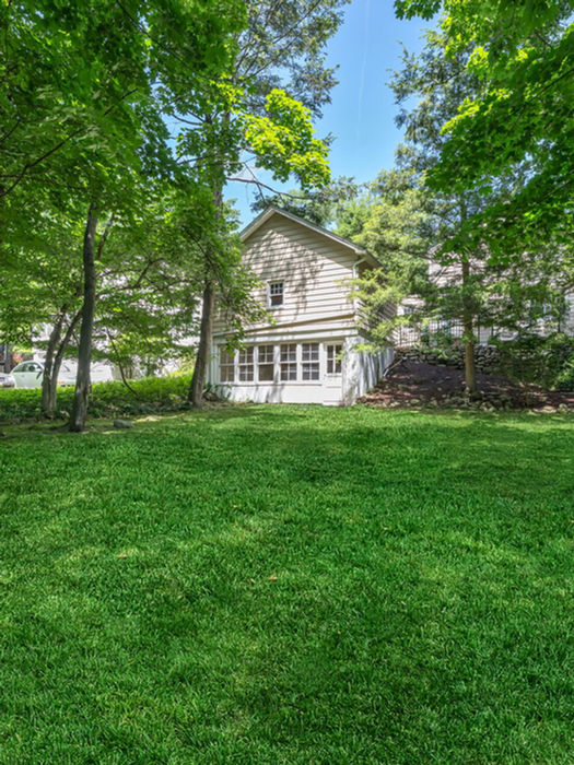 Expansive backyard at 552 Hillcrest Road Ridgewood NJ featuring a lush green lawn, mature trees, and private outdoor space perfect for entertaining and enjoying the Ridgewood lifestyle.