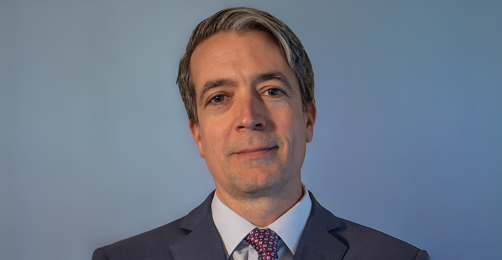 Headshot photo of Brendan H. Frey of Frey Law. He is wearing a navy blue suit with a light blue dress shirt. He is wearing a maroon tie with light blue patterning. He looks kind and thoughtful.