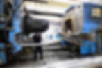 Operator removing a waste collection bin from injection press