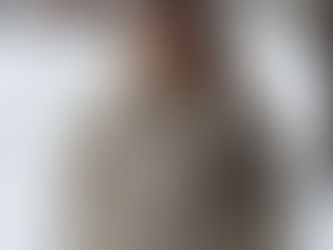 Elegant woman in a fur coat smiling outside salon in winter snow after hair and brow makeover – Mequon WI.