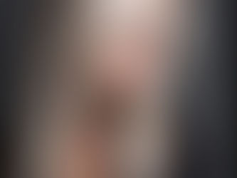 Woman with glossy platinum blonde layered highlights and brown lowlights, styled for a fall hair color makeover.