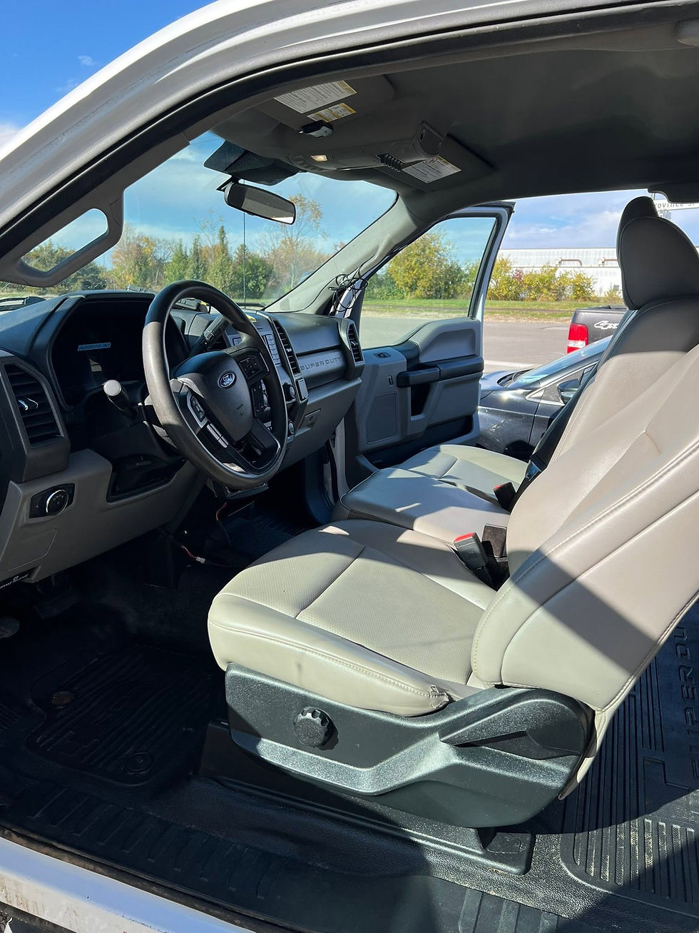 Cleaned truck interior with gray seats and black floor mats