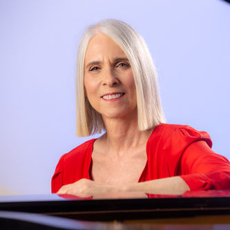 Lisa with grand piano in music studio