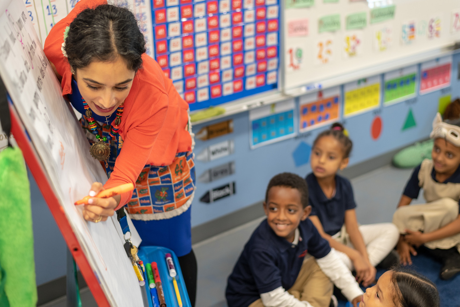 Charter School Teach Writing on Board to Class