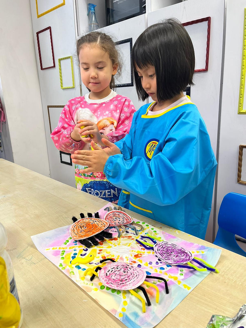 Two children doing a spider-themed art project