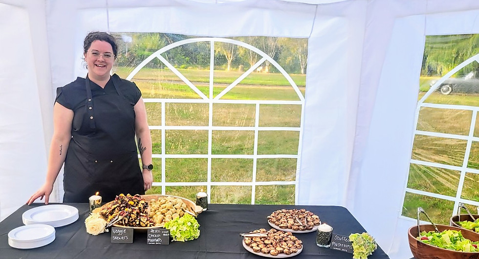 Chef/Owner Cara (white woman mid 30s brown hair) presents catered appetizers