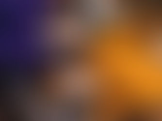 Pexels photo - Two people smile as they lie on the ground covered with autumn leaves. One wears an orange sweater and matching hat, while the other wears a purple sweatshirt. They both touch each other's cheeks in a cheerful and relaxed manner, with a white thermos beside them.