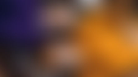 Pexels photo - Two people smile as they lie on the ground covered with autumn leaves. One wears an orange sweater and matching hat, while the other wears a purple sweatshirt. They both touch each other's cheeks in a cheerful and relaxed manner, with a white thermos beside them.