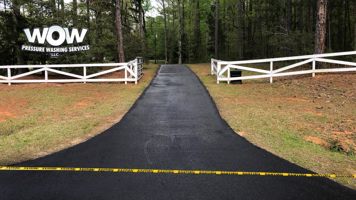 Beautiful pitch black driveway refreshed by wow pressure washing services llc