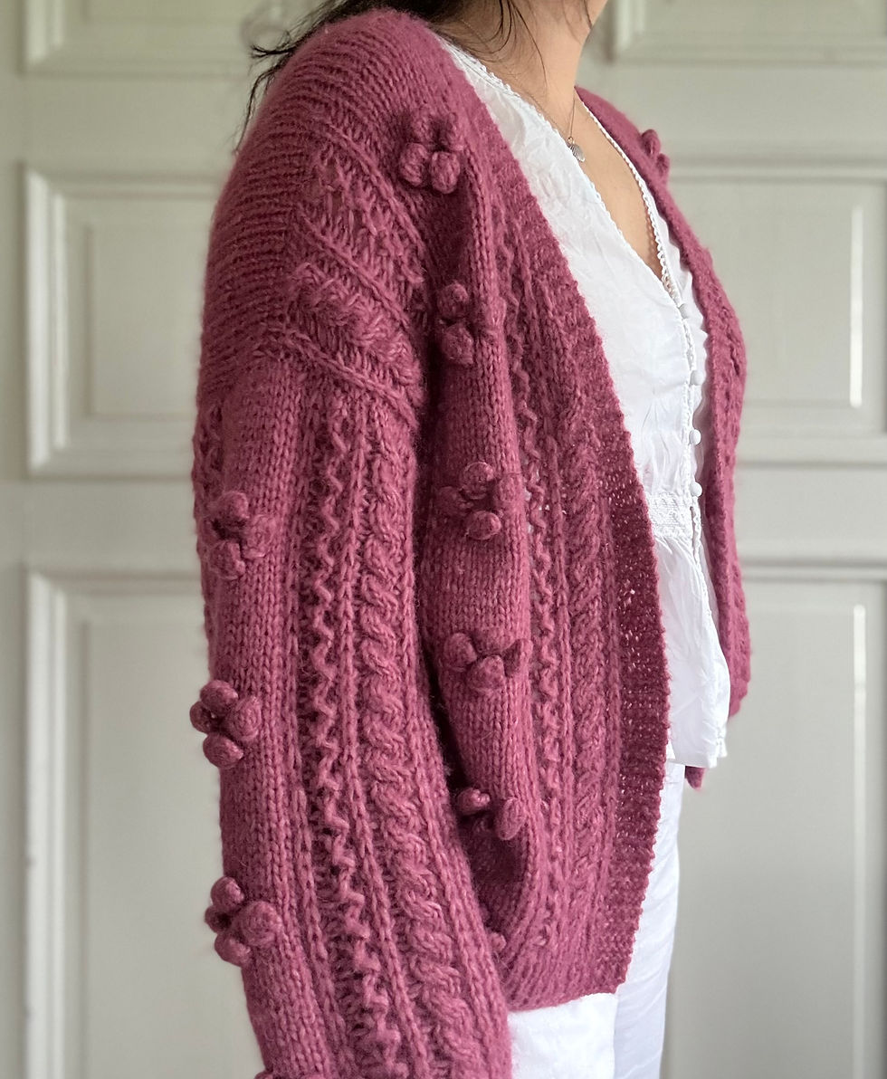 Thumbnail: I do2 Cardigan by MyChicKnits - a delicate knitting pattern my Marthe Øyrås featuring bobbles, cables and eyelets