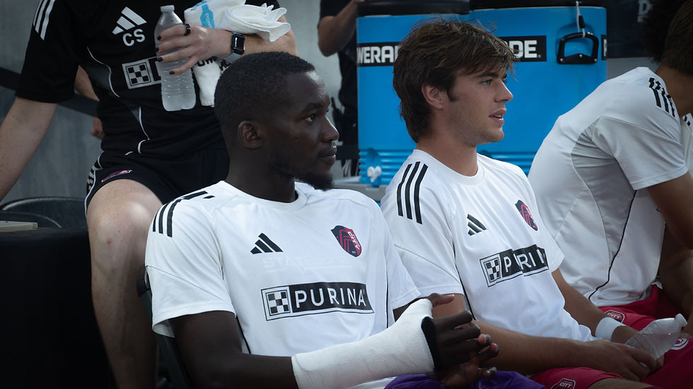 Fallou Fall (right) and teammate Brendan McSorley (left) on the bench before St. Louis City SC’s pre-match friendly against Aston Villa.