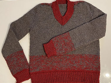 A red and grey knit sweater.