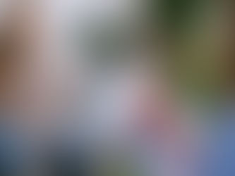 Female coach taking notes from female client sitting in front of her.