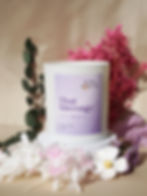 Floral soy wax candle that has the word "Thai massage" printed on it