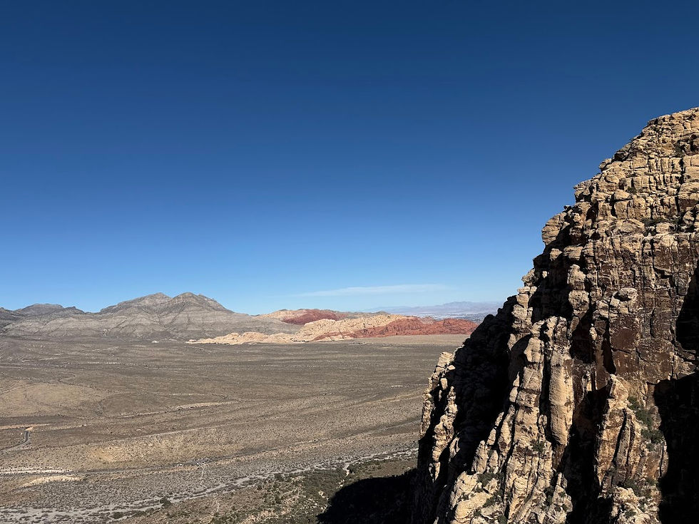 Eye-level view of the vibrant red rock formations under the clear blue sky at Red Rock Canyon