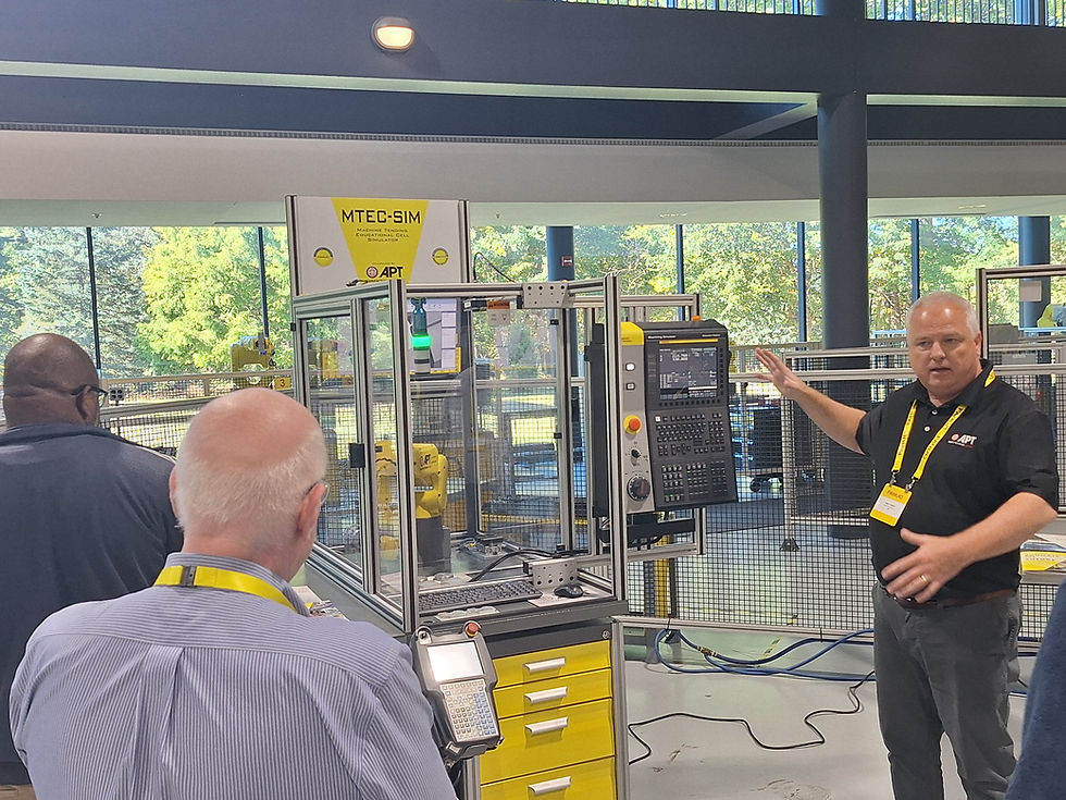 An APT Manufacturing representative presents machinery to attendees at the 2025 NCNGM Summit, held at FANUC America Corporation, in collaboration with the National Coalition of Advanced Technology Centers (NCATC).