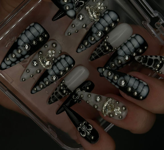 black and white press-on nails with silver gems. long almond gel nails.