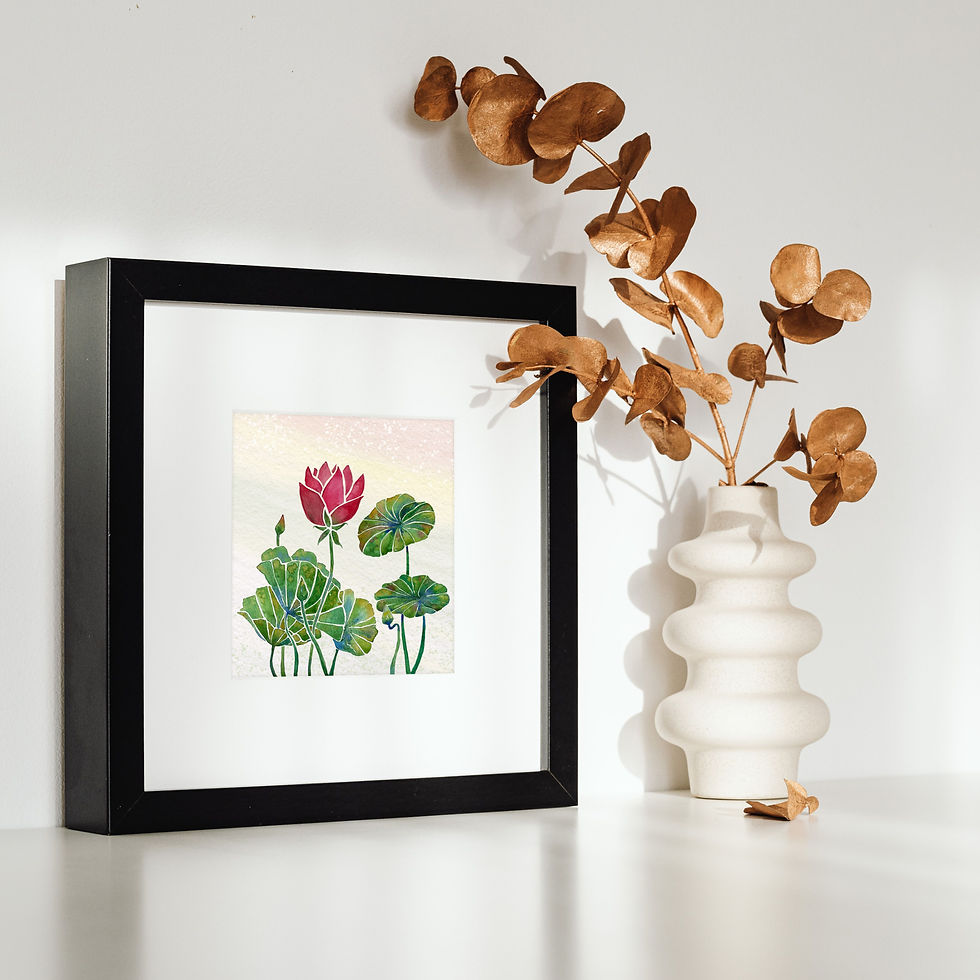 Boho sun room with green plant and a chair with a stack of blankets. A watercolour painting of a lotus flower and leaves hangs in a frame on the wall
