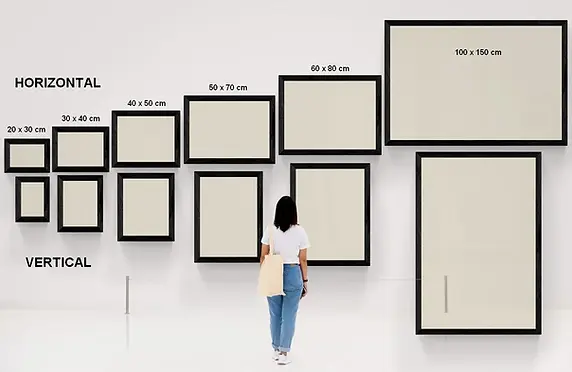 woman-and-large-gallery-wall-laurence-saunois-sizes-vertical-horizontal.webp