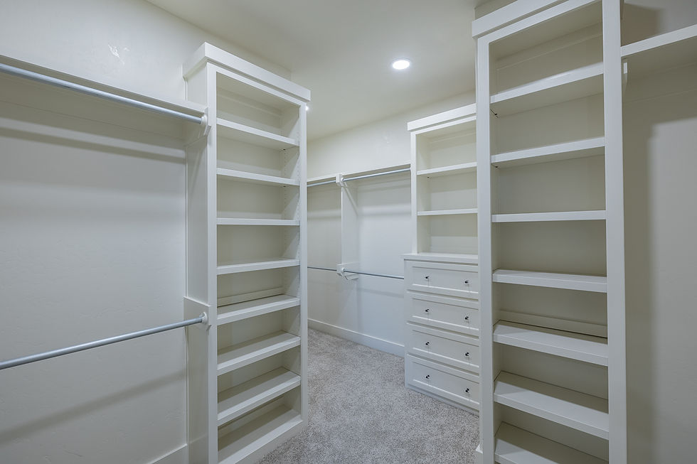 Master closet with built in dressers and shoe racks