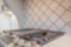 Designer selected tile with gas cooktop and double oven
