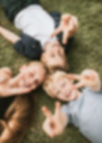 kids-lying-on-a-grass-family-photo-2023-11-27-05-19-45-utc.jpg