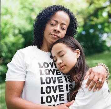 Woman embracing young girl