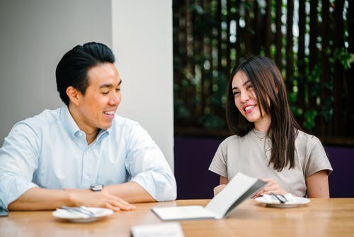 man and woman talking at a table