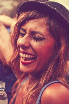 woman in a hat laughing