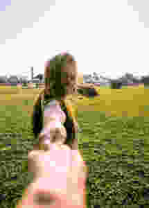 Woman holding hand of someone and smiling