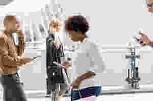 people walking and talking with their digital devices