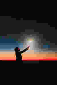 woman in the dark with a wand