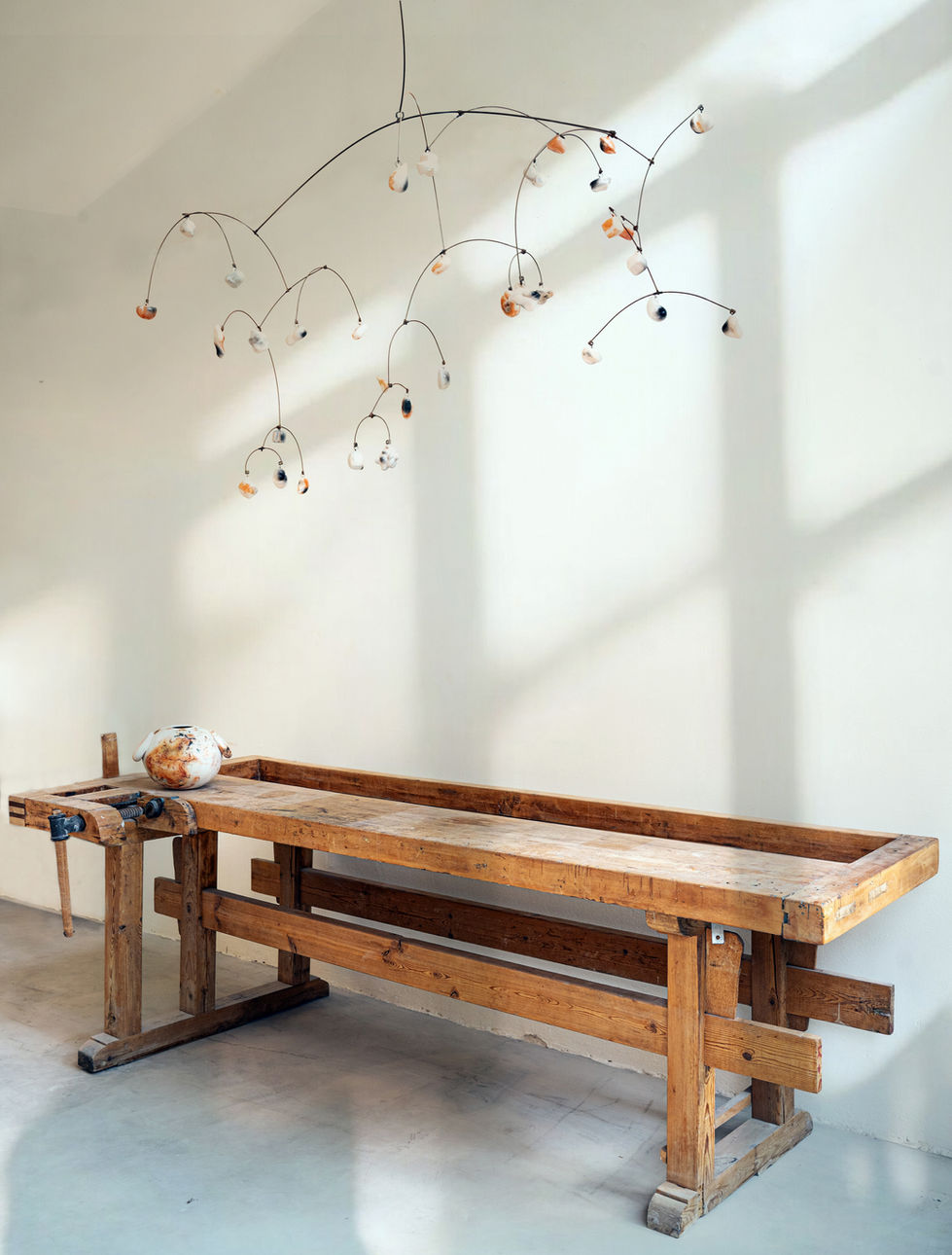 Kinetic Sculpture, saggar fired ceramic pieces suspended from metal strings.