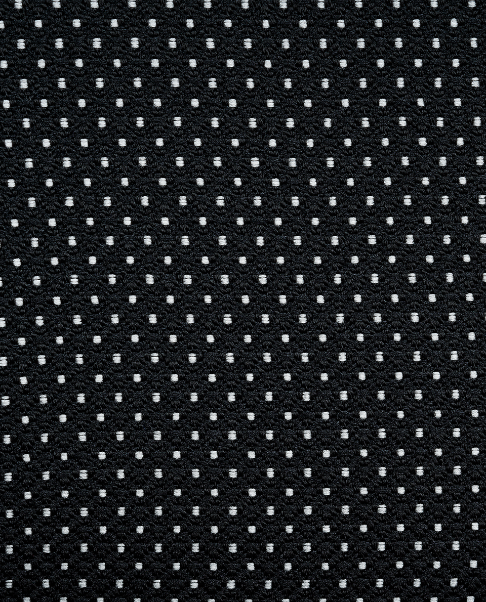 The grey pin dot tuxedo fabric close up shot.