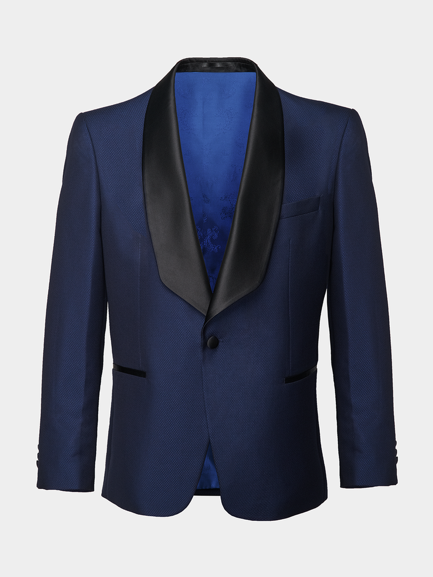 A midnight blue tuxedo jacket with shawl black satin lapels ghost shot on a light grey background.