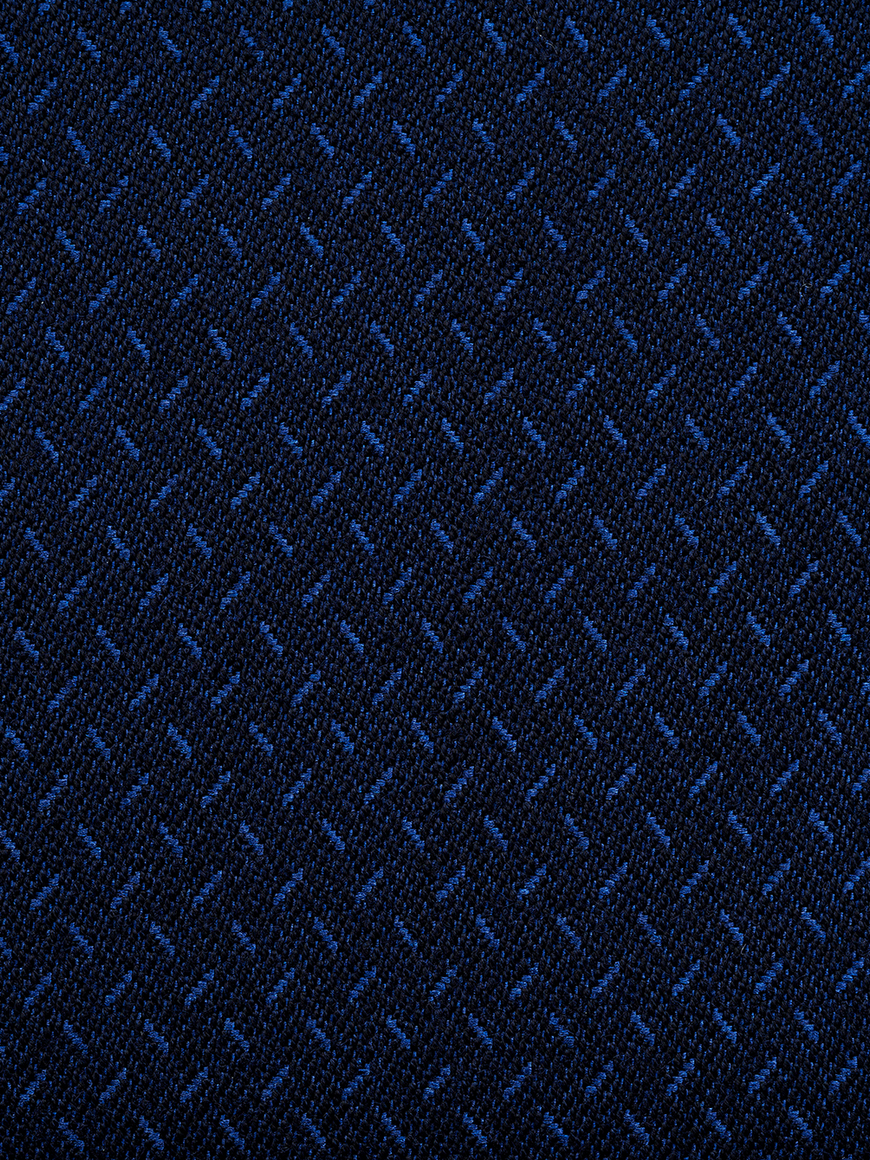 The midnight blue tuxedo fabric close up shot.