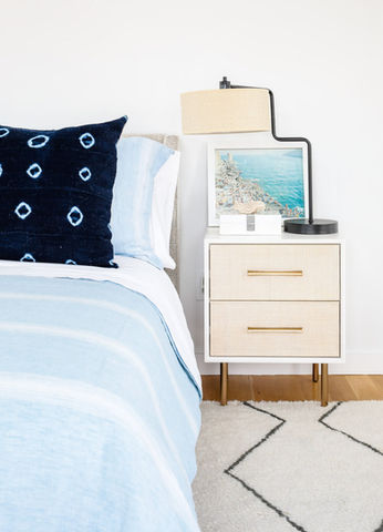 Bedside table with lamp and framed photo