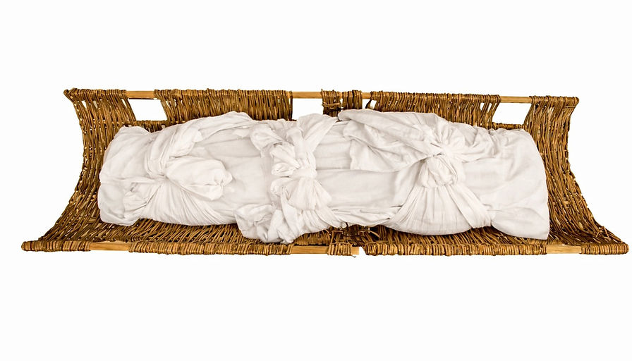 Burial shroud made from pure Irish linen displayed on a willow stretcher.