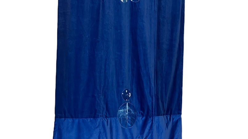 Unfolded deep blue velvet burial shroud with ecoprinted white botanical prints,