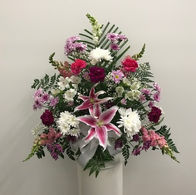 A flower arrangement with pink, purple, and white flowers