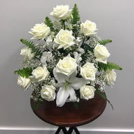 A flower arrangement with white roses