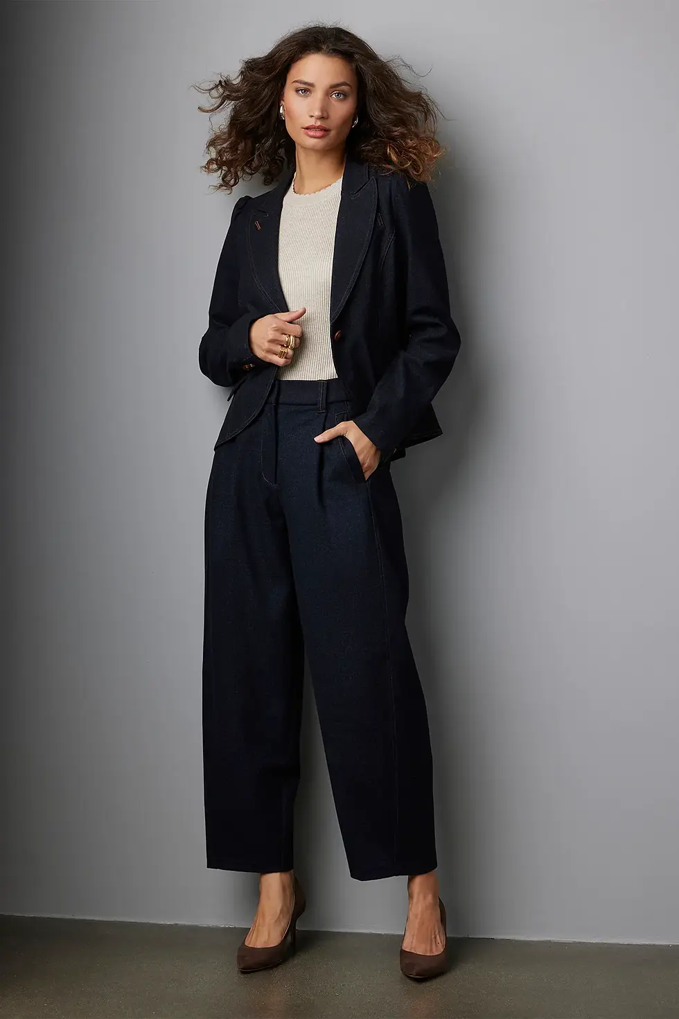 Woman wearing black tailored jumpsuit with heels showcasing modern minimalist style and flattering fit