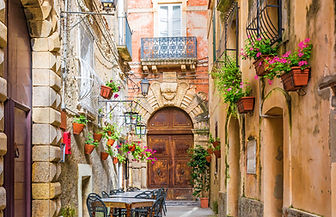 Cafe tables and chairs outside in old cozy street in the Positano town, Campania, Italy.jp