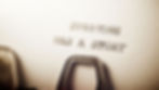 Close-up of a typewriter typing "EVERYONE HAS A STORY" on white paper, with sepia tones creating a nostalgic mood.