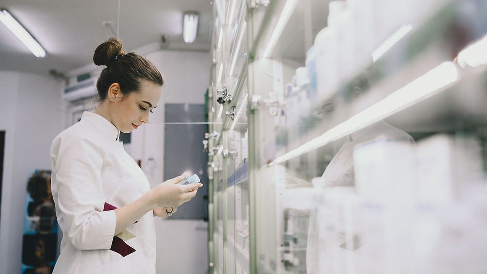 Pharmacist in white coat examines a product in a bright, modern pharmacy. Shelves with various items are visible, creating a focused mood.