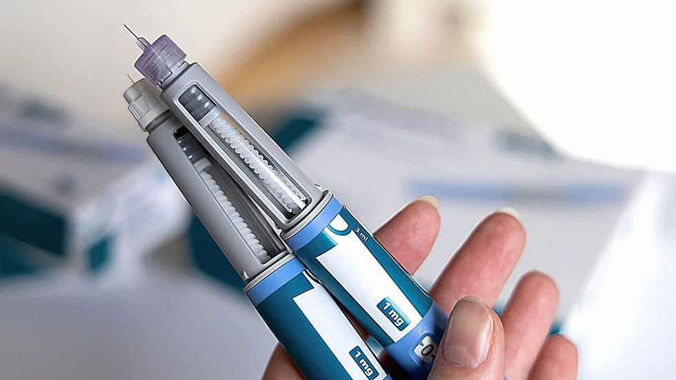 Hand holding two blue insulin pens with visible needles. Background is blurred with white and teal colors. Labels read "1 mg" and "3 ml".