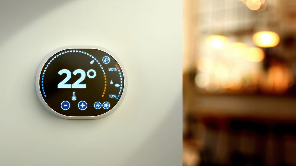 Smart thermostat on a light wall displays 22°C, surrounded by blue and orange indicators. Blurred warm-lit room in the background.