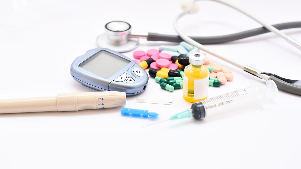 Medical tools on a white background: glucose meter, syringe, insulin pen, pills, stethoscope, and yellow vial, suggesting healthcare.
