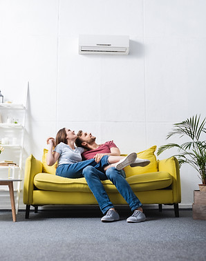 happy couple at home with air conditioner.jpg