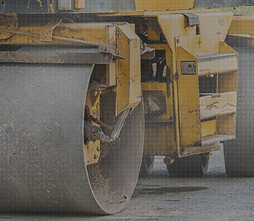 Heavy construction compactor compacting soil for efficient groundwork and stability.